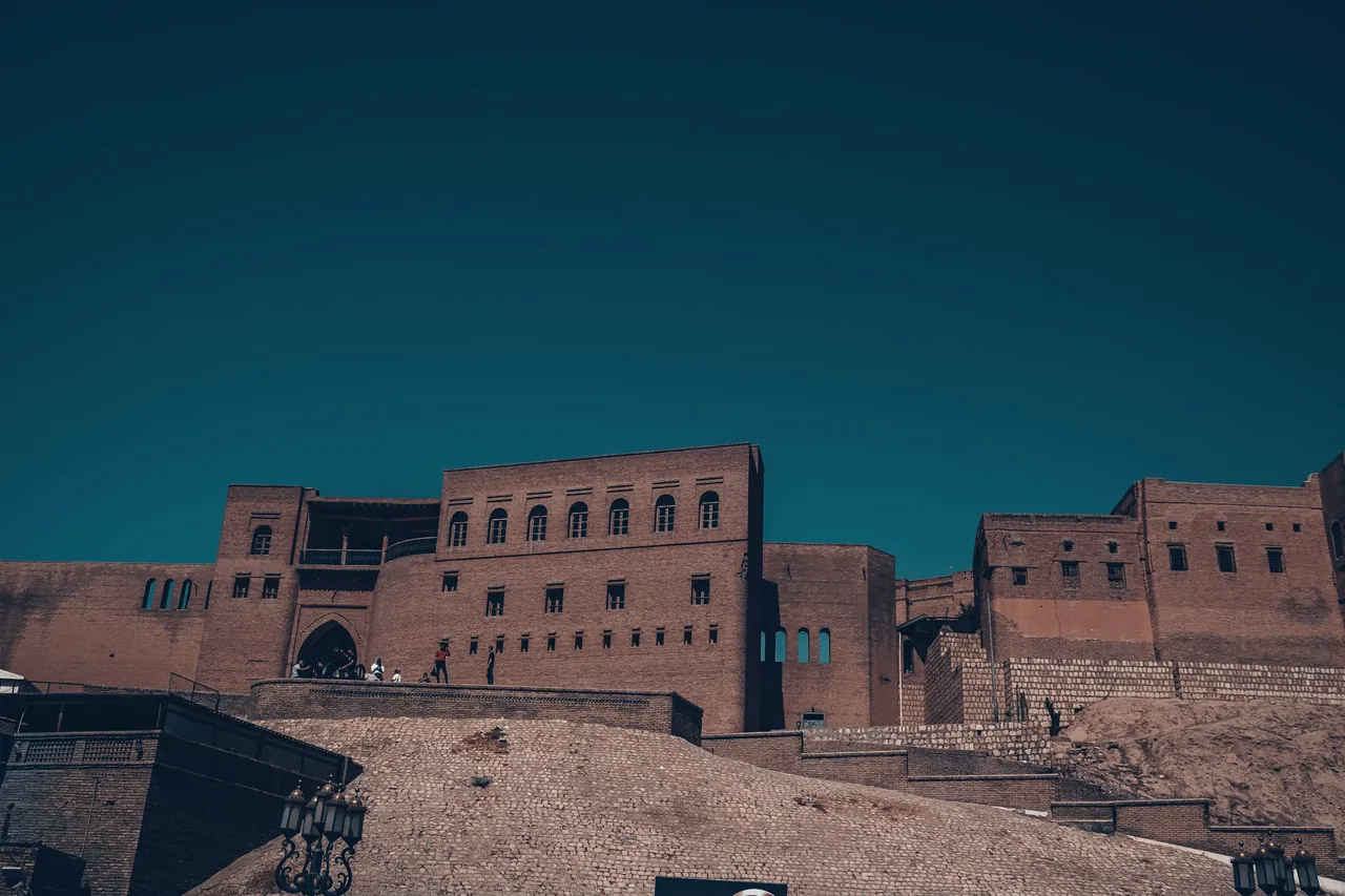 The brick walls of an old citadel against a clear sky