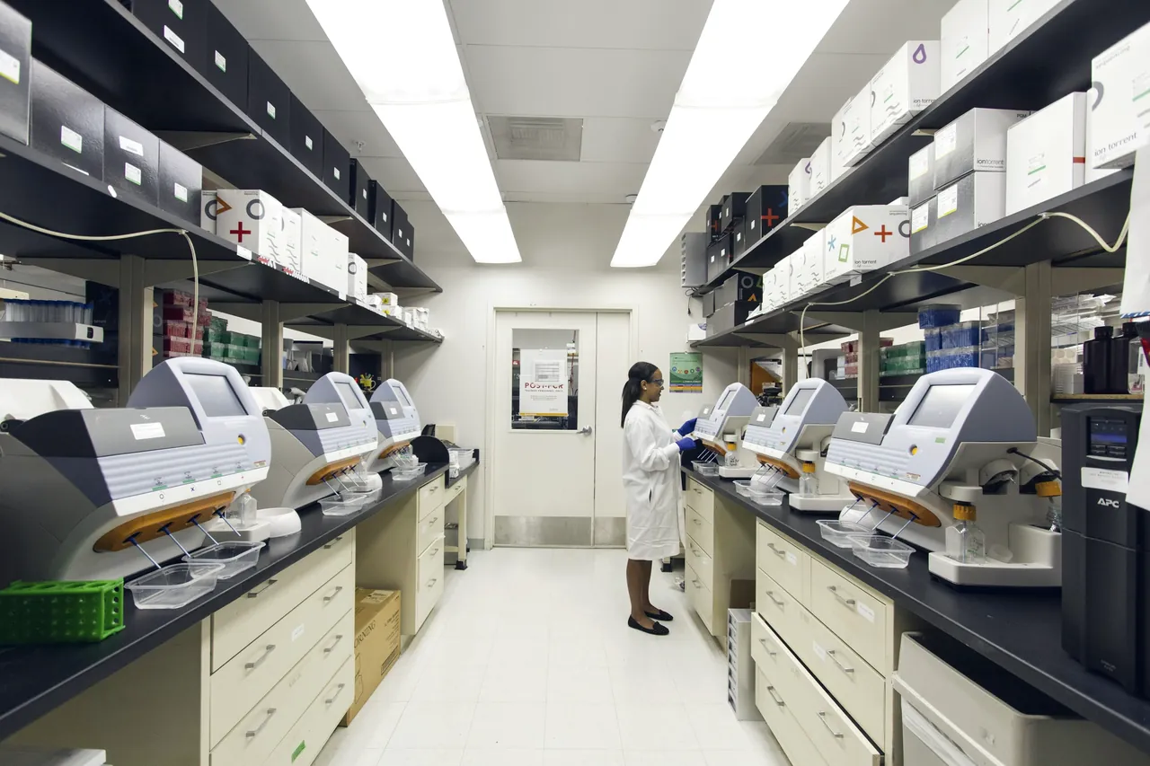 A long laboratory with benches of instruments on both sides