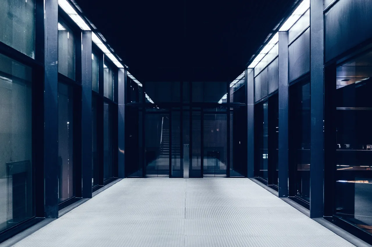 A corridor between glass-fronted server racks in a data centre